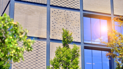 Exterior of a modern industrial building with green environment. Corporate building reduce CO2. Eco building.