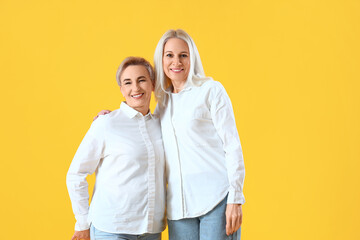 Beautiful mature women on yellow background
