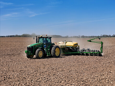 Poplar Grove, ILLINOIS - April 25. 2024: John Deere 8230 tracter pulling a John Deere 1770NT planter
