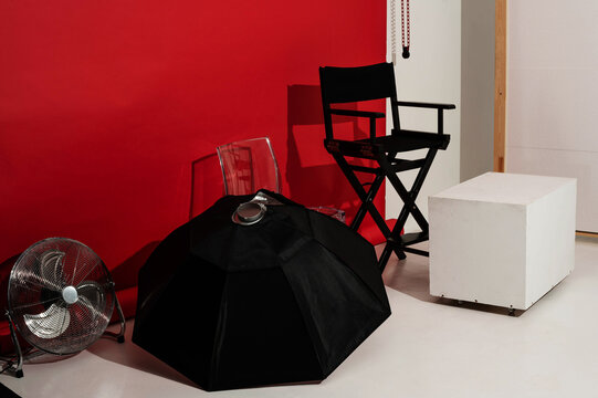 Octobox, photo studio equipment and red paper background for shooting. Wooden cube, chairs and fan for quickly changing locations during photoshoot. Organization of photoshoots for brands at cyclorama