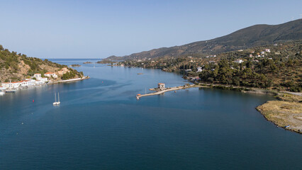 Obraz premium Aerial panorama of the city and harbor of Poros island in the Saronic Gulf, Greece, during a colorful summer sunset