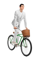 Smiling man riding bicycle with basket on white background