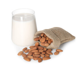 Glass of almond milk and almonds isolated on white