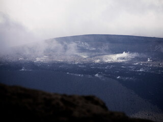 fuming volcanic crater of shinmoedake in Kyushu, japan. Close up of desolated volcanic landscape with fumaroles and dark rocks and ashes