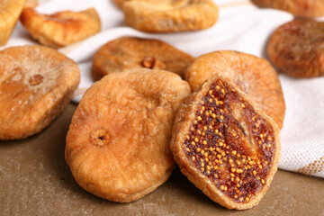 Sweet dried figs on brown background