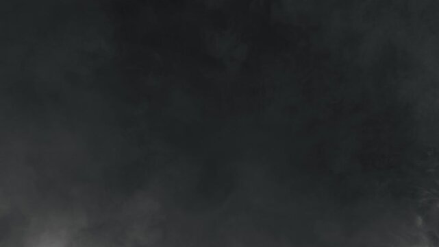 Super Slow Motion Shot of Atmospheric Smoke Slowly Floating on Black Background at 1000fps.