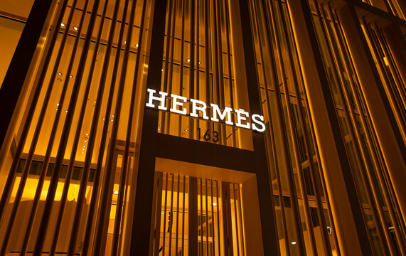 Herm&egrave;s sign at night, Miami Design District Florida, USA - 6/18/2024: The storefront sign in Miami's famous luxury Design District.