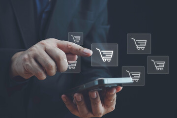 Online shopping, order in online store, shopping on internet, concept on virtual screen with hands typing on keyboard, Man using laptop with shopping cart icon. Online shopping and e-commerce concept.