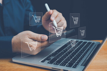 Online shopping, order in online store, shopping on internet, concept on virtual screen with hands typing on keyboard, Man using laptop with shopping cart icon. Online shopping and e-commerce concept.