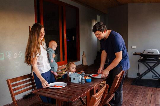 Family getting ready for barbeque dinner on back deck