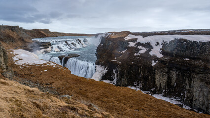 Stunning Gullfoss Waterfall with Snowy Cliffs in Iceland