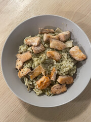 A bowl of risotto with salmon.