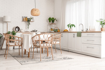 Interior of kitchen with white counters and dining table