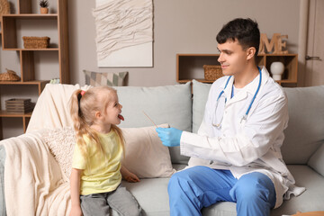 Fototapeta premium Male pediatrician examining little girl with tongue depressor at home