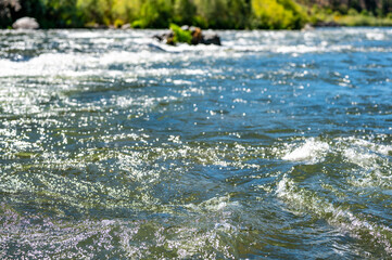 defocused Water level view the wild and scenic Rogue River with rafters in the distance. 