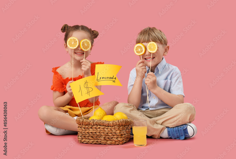 Canvas Prints Cute children with basket of lemons selling lemonade on pink background