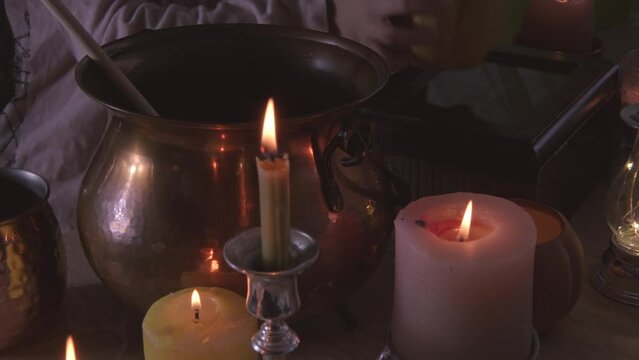 young witch stirs mystical potion in copper cauldron, adding charm to Halloween party atmosphere, magical potion, whimsical charm