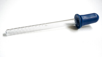 Fototapeta premium Glass dropper isolated on white background. Pipette with dose marking in ml units for medicine