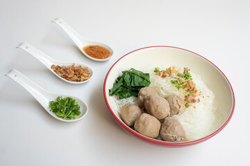 Bakso Meatballs and Rice Noodles with Soup Served Chili Sauce, Indonesia Food Style Popular Street Food served on bowl with chili sauce, chopped celery and fried onions sideview