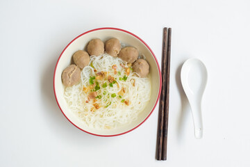 Bakso Meatballs and Rice Noodles with Soup Served Chili Sauce, Indonesia Food Style Popular Street Food served on bowl with chopsticks and spoon