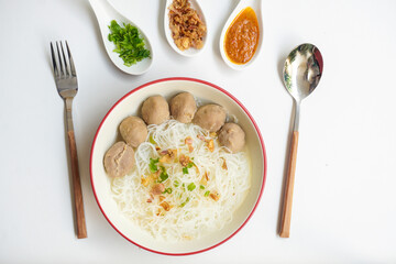 Bakso Meatballs and Rice Noodles with Soup Served Chili Sauce, Indonesia Food Style Popular Street Food served on bowl with chili sauce, chopped celery and fried onions sideview