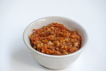 Indonesia traditional cuisine sambal bawang or spicy garlic chili sauce served on a white bowl isolated on white background.