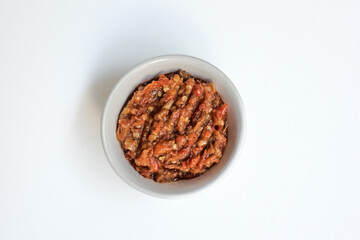 Indonesia traditional cuisine sambal bawang or spicy garlic chili sauce served on a white bowl isolated on white background.