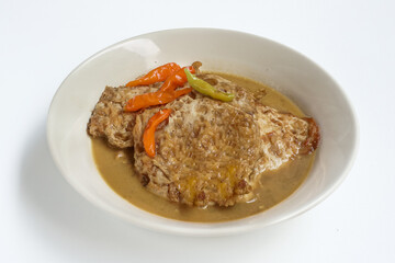 Telur ceplok masak kecap or fried eggs with sweet soy sauce. Served in white plate. Selective focus.