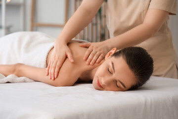 Young woman getting massage on couch in spa salon, closeup