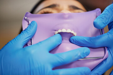 Dentist, dental and rubber dam for toothache in clinic, health and treatment for cleaning mouth. Teeth whitening, smile and person with torque wrench machine, orthodontics and oral care for veneers