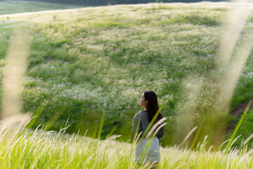 Asian woman who is lonely. In the grass, she is happy.