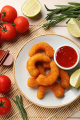 Tasty breaded fried shrimps served on light wooden table, flat lay