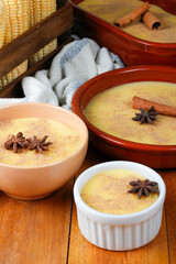 Curau, cream of corn sweet and dessert typical of the Brazilian cuisine, placed in ceramic bowl on wooden table.