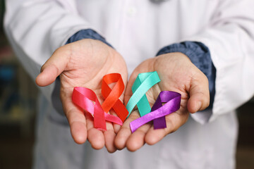 Cupped Hands Professional Doctor Showing Colorful Ribbons On Palms. World Cancer Day.