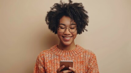 young black woman looking down at phone smiling 