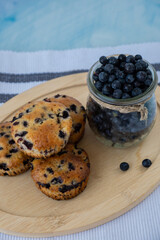 Homemade baked blueberry muffins with fresh harvested blackberries in glass jar. Tasty pastry sweet cupcake dessert. Berry pie cupcakes with organic berries. Gluten free healthcare recipe 