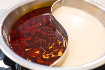Chinese hot pot with double flavor Sichuan pepper soup and bone soup. Shabu Shabu or Sukiyaki