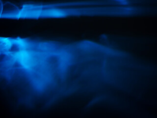 Obraz premium Blue glare in the dark for technology abstract background.