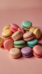 Fototapeta premium A flat lay of assorted pastel-colored macarons on a soft pink background, capturing the warm light of golden hour