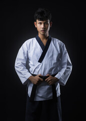 Portrait of a black belt taekwondo instructor standing in a fashion post