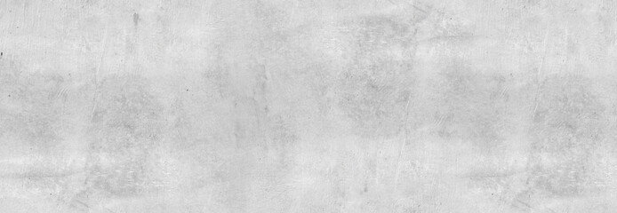 Large white grunge textured concrete wall background. The backdrop is a rough cement floor in gray tones.