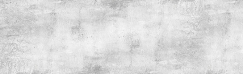 Large white grunge textured concrete wall background. The backdrop is a rough cement floor in gray tones.