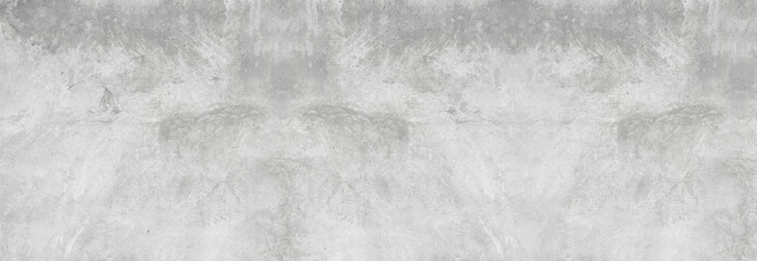 Large white grunge textured concrete wall background. The backdrop is a rough cement floor in gray...