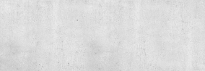 Large white grunge textured concrete wall background. The backdrop is a rough cement floor in gray...