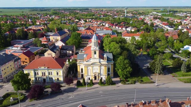Drone moves forward to show stunning aerial view of Szent Anna templom Church from above. Kapuvar, Hungary.