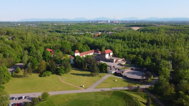 Drone moves left to right and enters in orbit view, house near river with lots of trees around and garden area. Ostrava, Czech Republic.