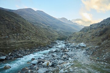 A mountain natural landscape with a mountain river. The season is early autumn.