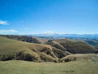 Fototapeta premium A natural mountain landscape. The highest peaks of the Caucasian ridge and Mount Elbrus, 5642 meters.