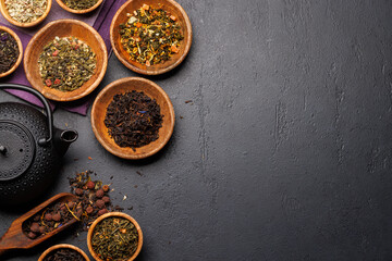 A collection of various teas nestled in wooden bowls