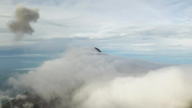 Grey plume of vog cloud from volcano floats above in sky of Guatemala